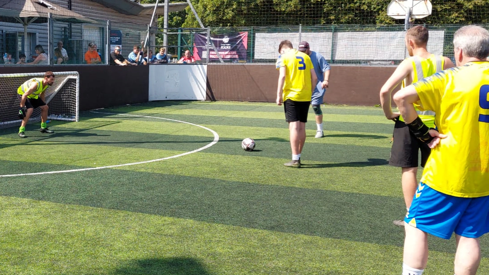 SC4 prepares to defend a penalty kick as players watch
